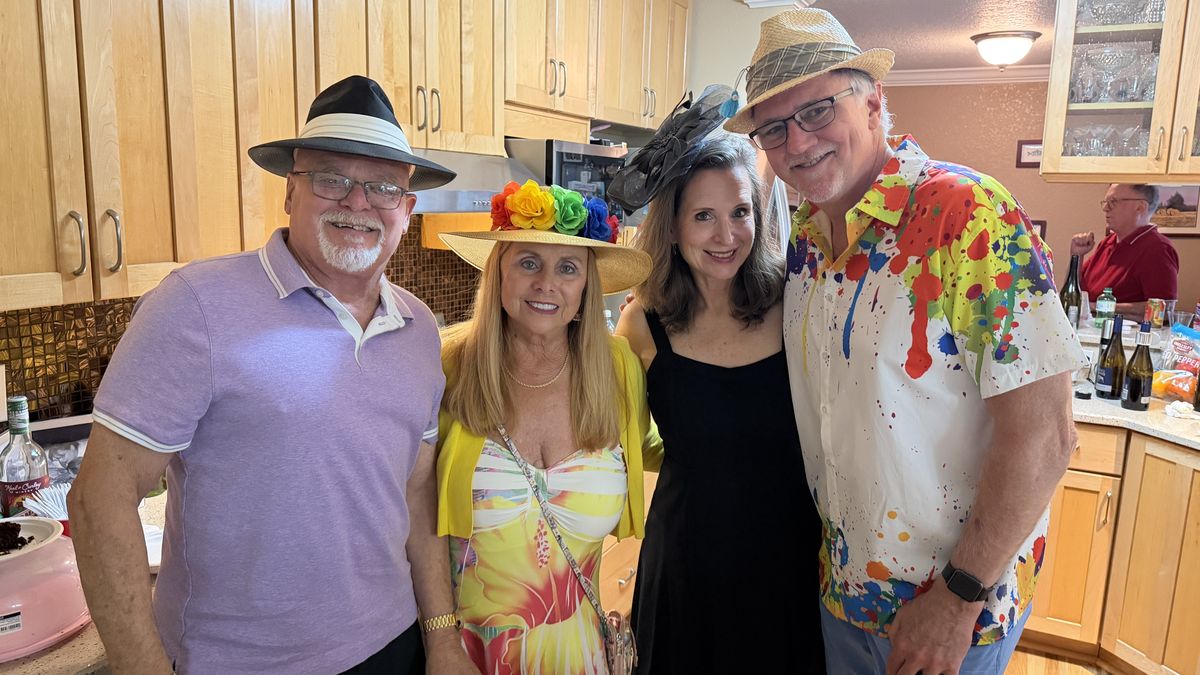 Members in Derby hats at a club party