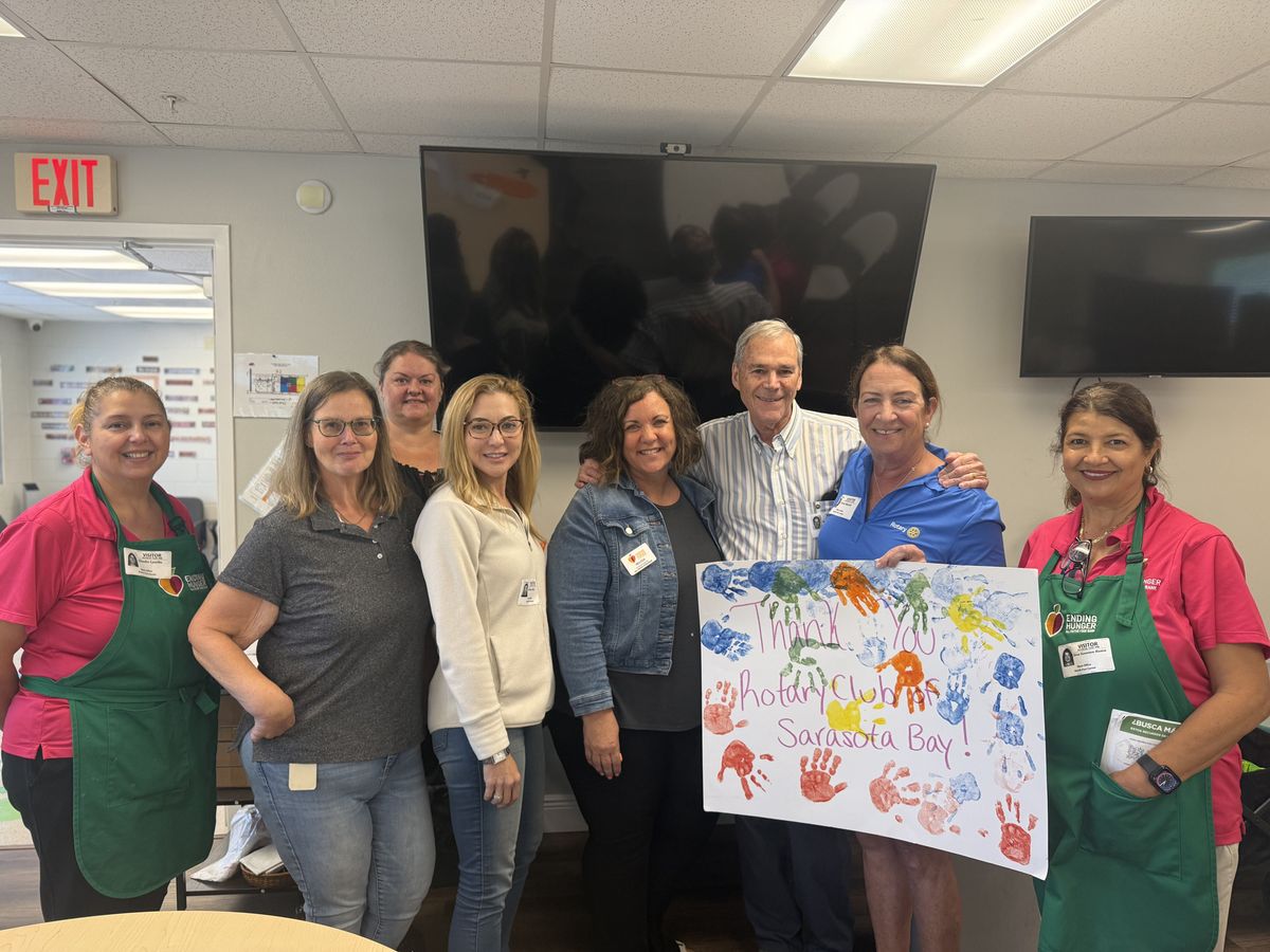 Club members with Children First staff and a handprint thank-you sign