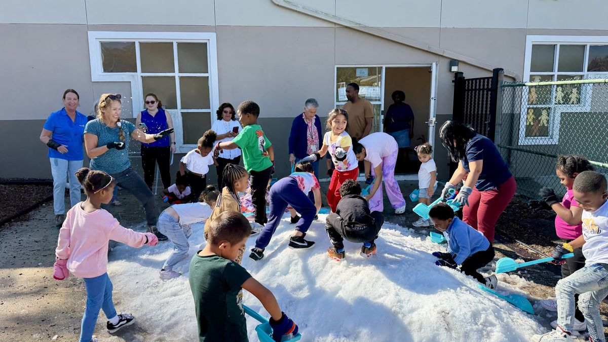 Children playing in a pile of snow at Children First in Sarasota